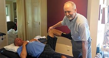 Tim Haitz receiving treatment from physical therapist Michael Noonan